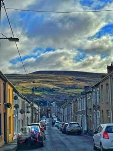 a street with cars parked on the side of the road at House in Ebbw Vale in Ebbw Vale