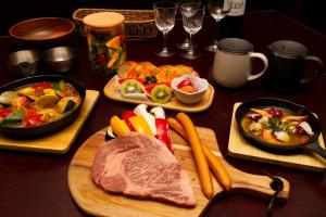une table recouverte de plaques alimentaires avec de la viande et des légumes dans l'établissement Kannami Springs Hotel Kannami Glamping - Camp - Vacation STAY 62738v, à Mishima