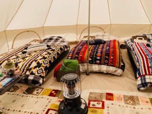 a group of pillows on the floor in a tent at Tanesashi Campsite - Camp - Vacation STAY 42215v in Hachinohe