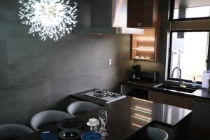 A kitchen or kitchenette at プラフィーノリゾートヴィラ