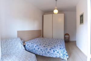 a small bedroom with a bed and a cabinet at il Golfo di Diana in Diano Marina