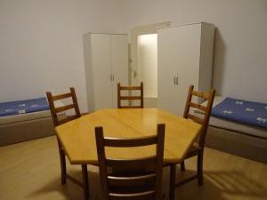 a room with a table and chairs and a bed at Apartment Essen-City in Essen