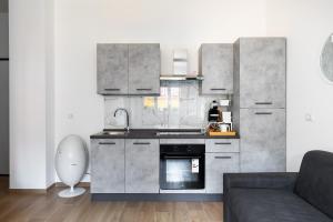 a kitchen with stainless steel appliances and a couch at La dimora degli asinelli in Bologna +11 photos