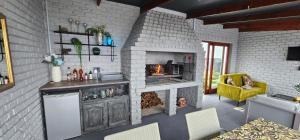 a living room with a brick wall and a fireplace at Mosselbay Dream Home in Mossel Bay