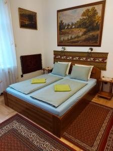 a bedroom with a large bed with two yellow pillows at Apartment in the "antique street" in Budapest