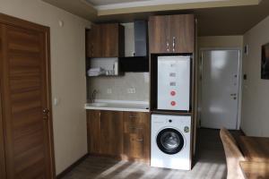 a kitchen with a washing machine in a kitchen at Center Room Otel in Yenimahalle