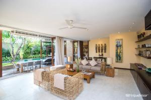 a living room with a couch and a table at The Elysian Boutique Villa Hotel in Seminyak