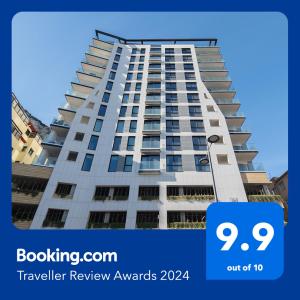 a tall white building with a sign that says travel review awards at Brand New Luxury 1 Bed 2 Bath Apartment - SPA, Pool & Gym in Gibraltar