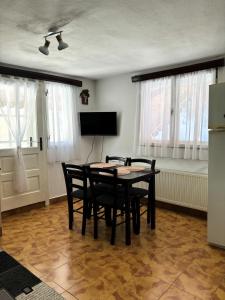 a dining room with a table and chairs at Casa TOR - Moieciu de Jos in Moieciu de Jos