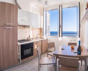 a kitchen with a table and a dining room at da Guido in Imperia