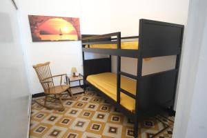 a room with two bunk beds and a chair at da Guido in Imperia