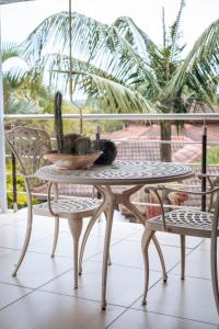 a table and chairs on a balcony with a cactus at White River Country Estate - Self Catering - AMH Home in White River