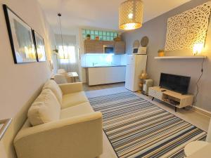a living room with a couch and a kitchen at Santa Cruz Ocean Apartment - II in Santa Cruz