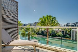 a balcony with a chair and a view of a pool at 308 Juliette in Cape Town