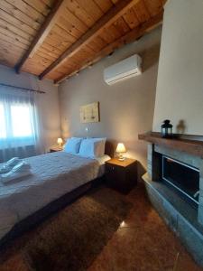 a bedroom with a large bed and a fireplace at Guesthouse Platon in Órma +57 photos