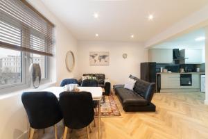 a living room with a table and chairs at Orange Rentals- Studio apartment in the city centre of Liverpool in Liverpool