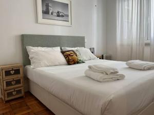 a large white bed with a face pillow on it at Garden 63 - Jardim da Parada - Campo de Ourique in Lisbon