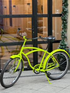 a yellow bike parked in front of a building at URBAN Penthouse FREE parking i rowery in Poznań
