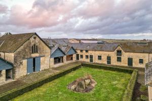 an aerial view of a large stone building with a yard at The Garret in Salisbury