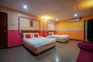 DJ Hotel Lumut客房内的一张或多张床位