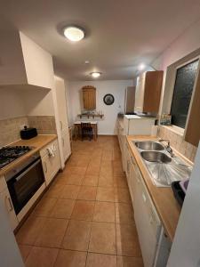a kitchen with a sink and a stove top oven at Spacious Home w/ Parking & Garden in Worthing