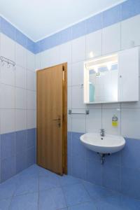 a bathroom with a sink and a mirror at Apartments Cipetic in Kaštela