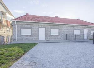 a brick building with three white doors on it at Mesão Frio by Guestify in Guimarães