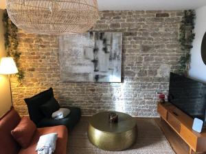 a living room with a couch and a coffee table at Séjour détente centre historique de MACON avec spa in Mâcon