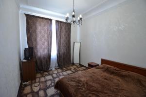 a bedroom with a bed and a window with curtains at Apartments on Sobornaya Street near the waterfront in Mykolaiv