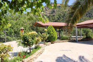 a garden with a pavilion with a mountain in the background at Casas Rurales Cortijo El Marqués in Quesada