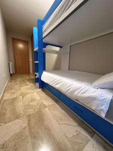 a bedroom with two bunk beds and a tile floor at DOLCE GAVA in Gavà