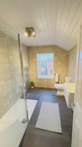 a bathroom with a shower and a sink at King-size bed en-suit, New luxury refurbished home in Newark-on-Trent