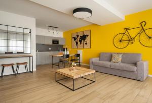 a living room with a couch and a bike on the wall at Donizetti Residence in Bergamo