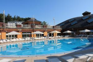 a large swimming pool in front of a hotel at Dora in Krapinske Toplice