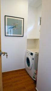 a washing machine in a room with a picture on the wall at Villa La Jade Chaweng Noi 2BR in Chaweng Noi Beach
