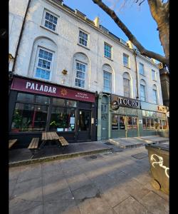 a building on a street with a bench in front of it at Studio in central London in London