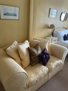 a white couch with pillows on it in a room at Goss Hall Bed & Breakfast in Sandwich