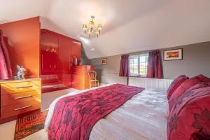 a bedroom with a large bed and a dresser at Cheney Hollow in Heacham