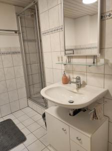 a white bathroom with a sink and a shower at Appartement in St. Niklaus in Sankt Niklaus