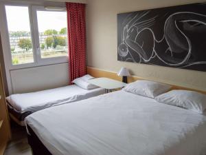 2 bedden in een hotelkamer met een raam bij ibis Boulogne sur Mer Centre les Ports in Boulogne-sur-Mer