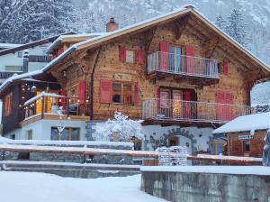 a log cabin in the snow with snow at Appartement in St. Niklaus in Sankt Niklaus