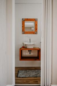 a bathroom with a sink and a mirror at Gecko Lodge in Robertson