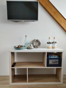 a tv on top of a wooden entertainment center at studio B&B Zeeuws licht in Westkapelle
