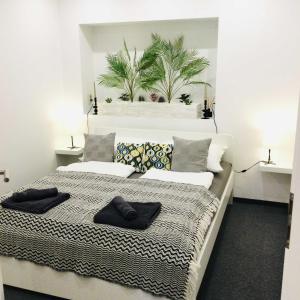 a bedroom with a bed with black towels on it at Baky House in Balatonlelle