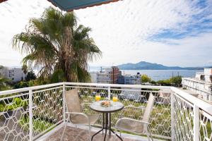 balcón con mesa, sillas y vistas al océano en Zoe Seaside, en Loutra Edipsou