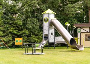 a playground with a slide in a park at Stonka in Chłopy