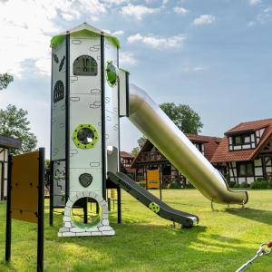 a playground with a slide in the grass at Stonka in Chłopy