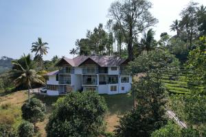 an aerial view of a house with trees at Elenji Revive Resort in Munnar