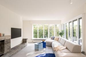 a living room with a couch and a fireplace at Bunker 155 in Ostend