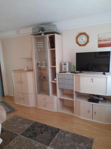 a living room with a tv and entertainment center at Ferienhaus im Spreewald - b46731 in Straupitz